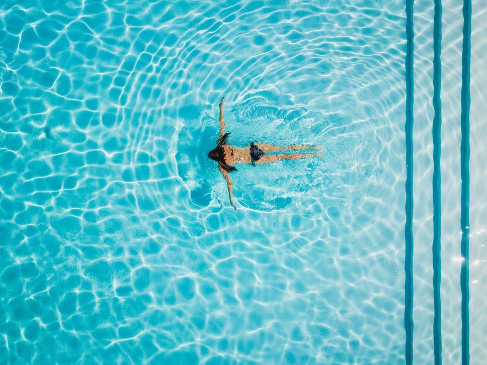 A person swimming in a pool.